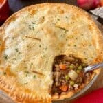 Ground beef pot pie crust and filling in pie plate.