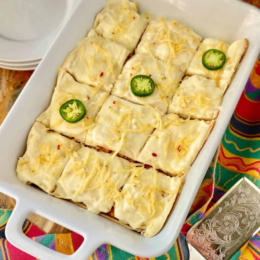 Sour Cream Enchilada Casserole in white baking dish.