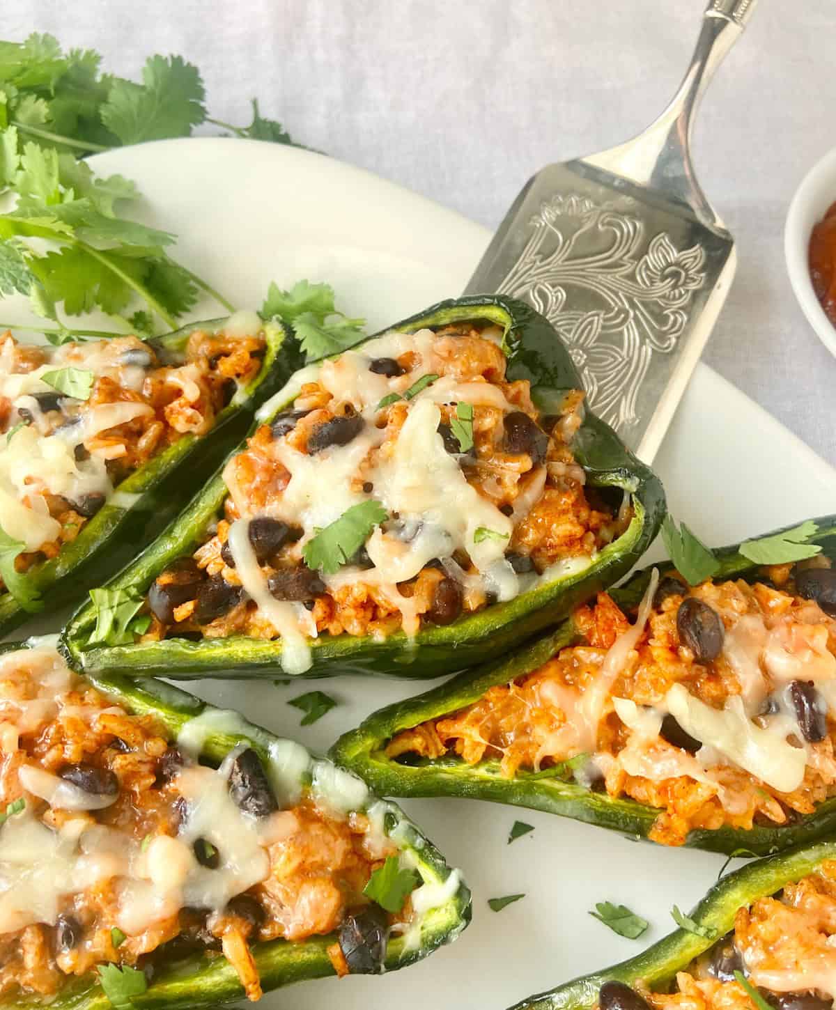 Stuffed poblano peppers on platter.