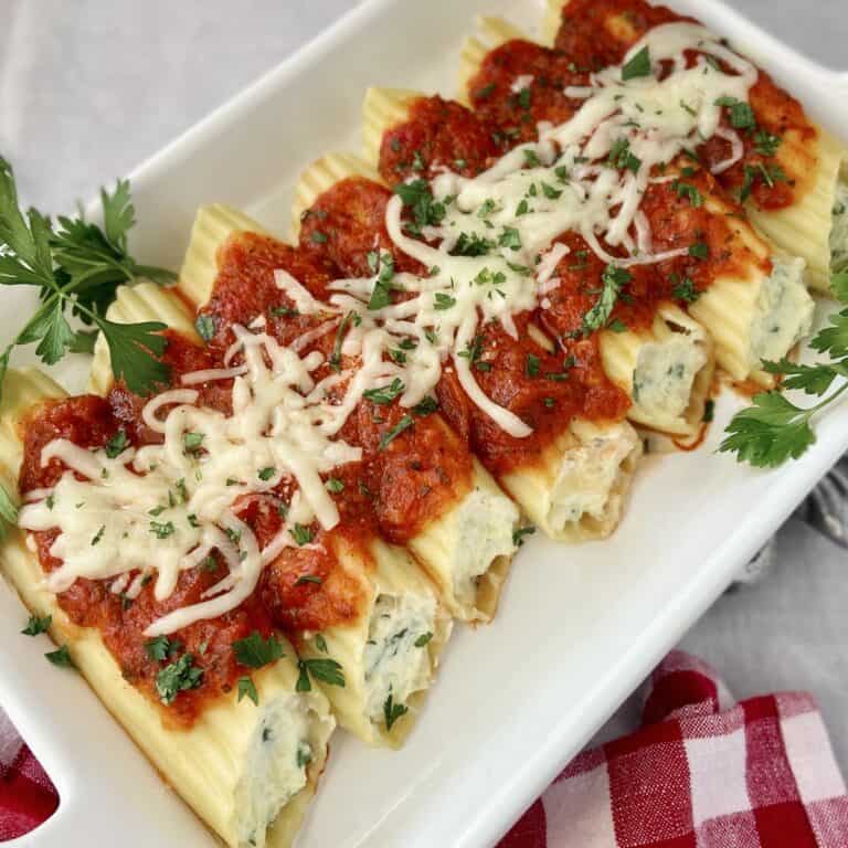 Manicotti shells topped with red sauce and Mozzarella cheese.