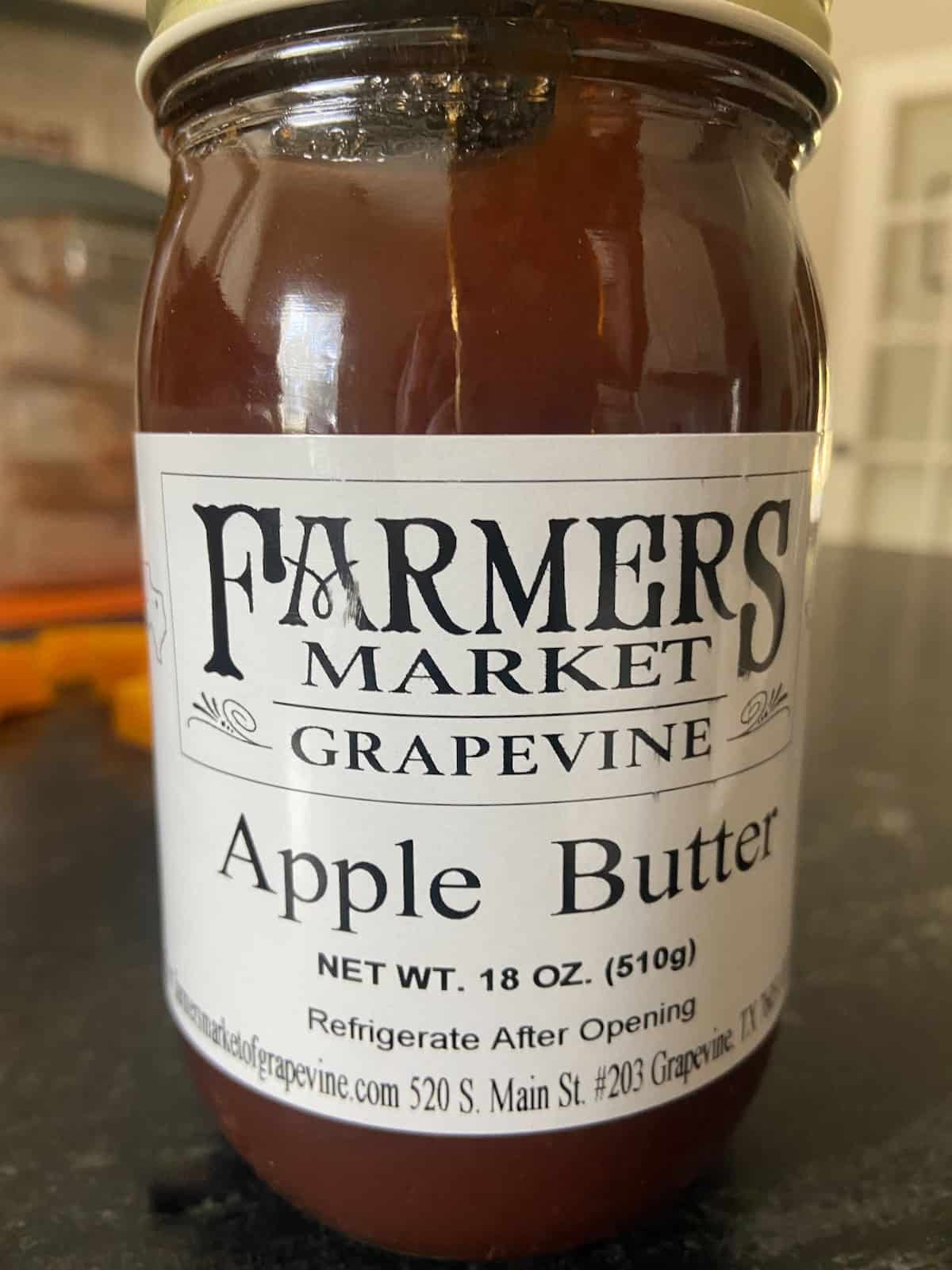 Jar of Apple Butter on counter top.