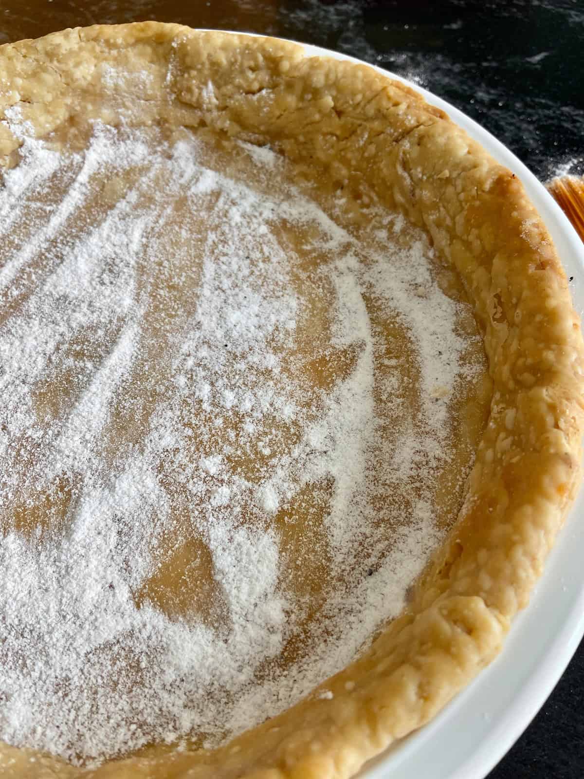 Crust dust sprinkled on blind baked pie shell.