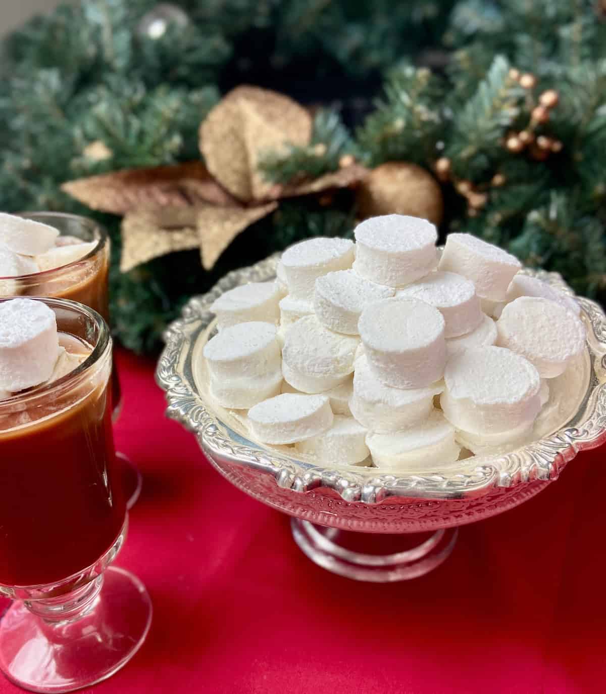 Homemade marshmallows stacked on a silver serving tray.