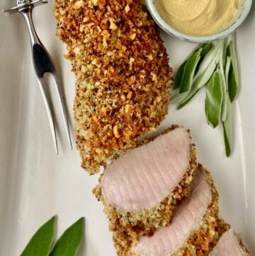 Panko Crusted Pork Tenderloin on white serving platter with a side of Dijon mustard.