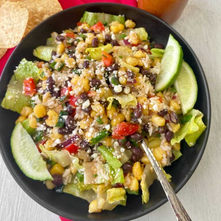 Mexican salad in a black bowl.