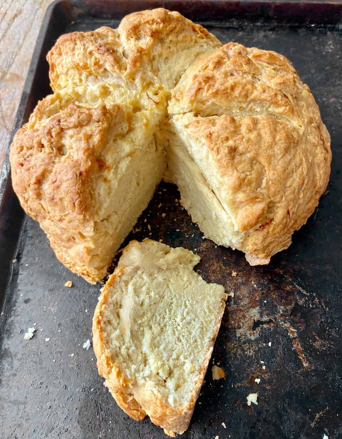 Sliced Irish soda bread on rustic baking pan.