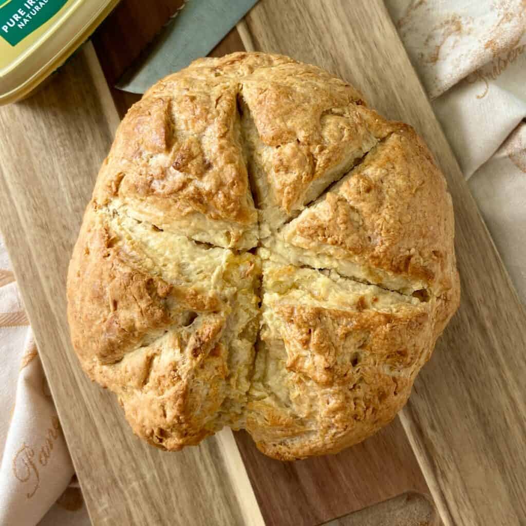 Round loaf of Irish soda bread scored on top.