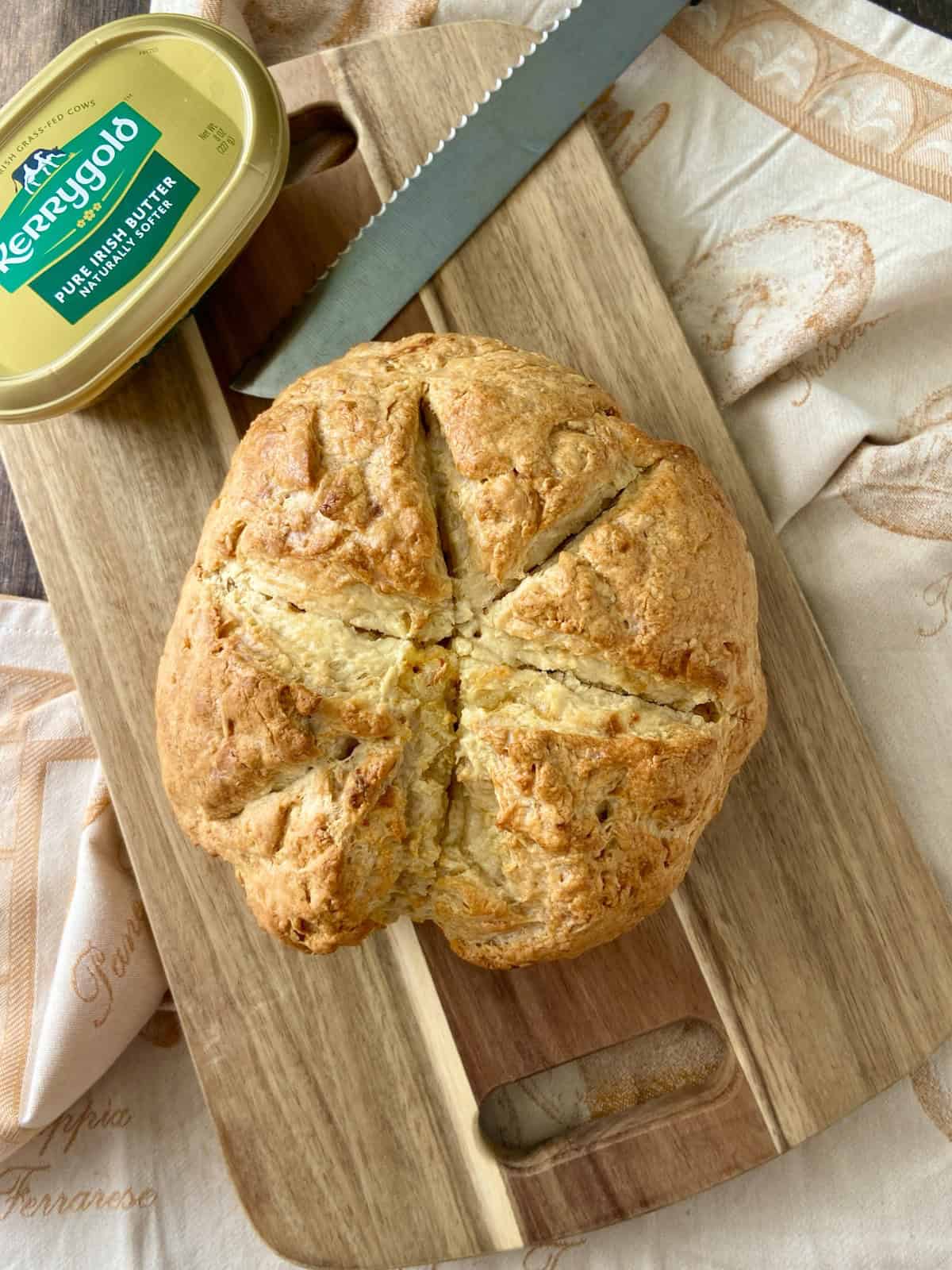 Irish soda bread on wooden cutting board.