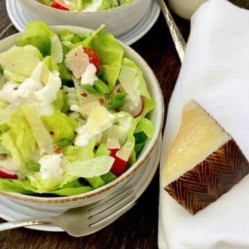 Shredded Manchego cheese on Bibb lettuce salad.
