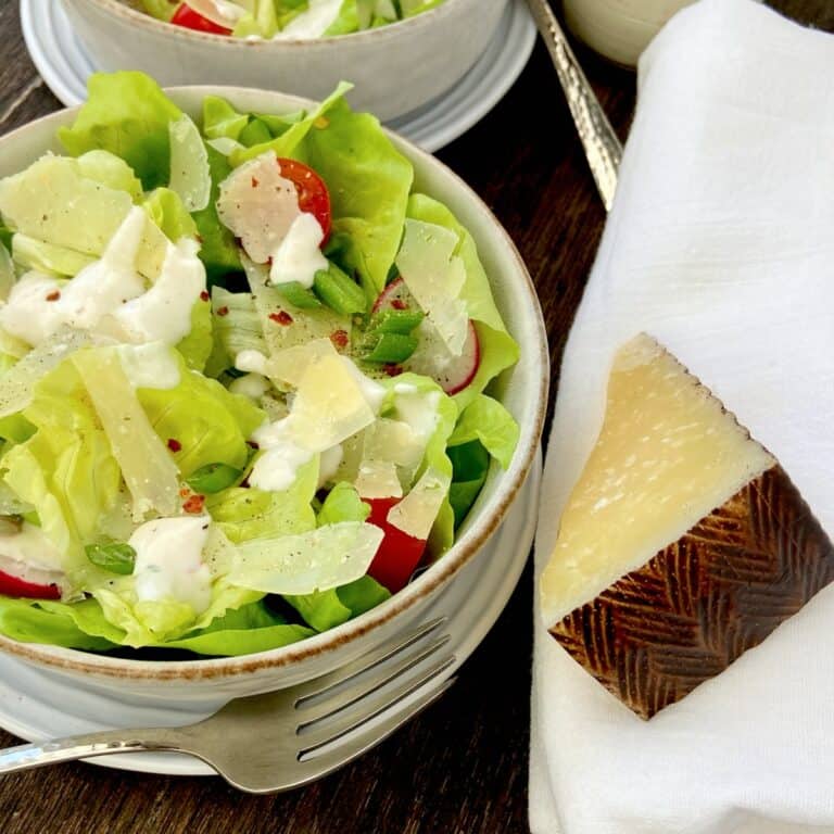 Shredded Manchego cheese on Bibb lettuce salad.