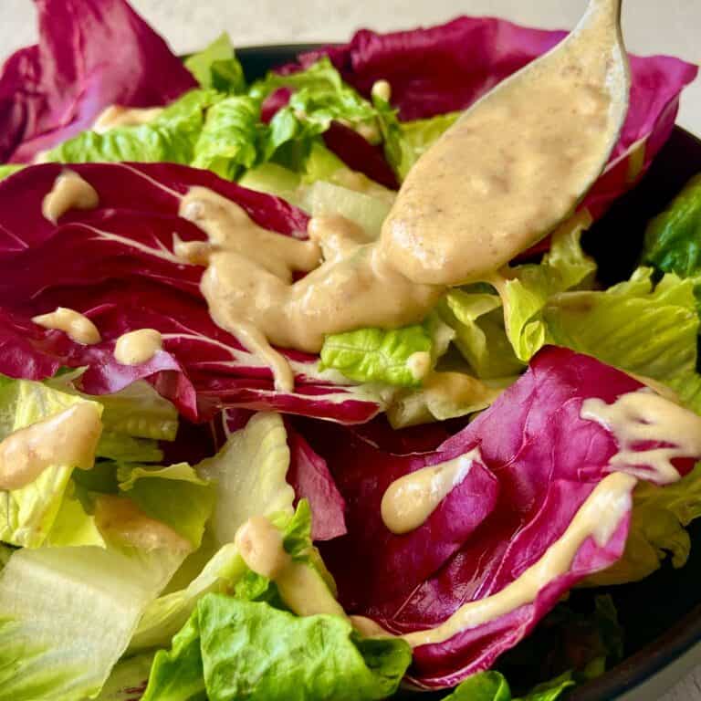 Creamy date vinaigrette over bed of greens.