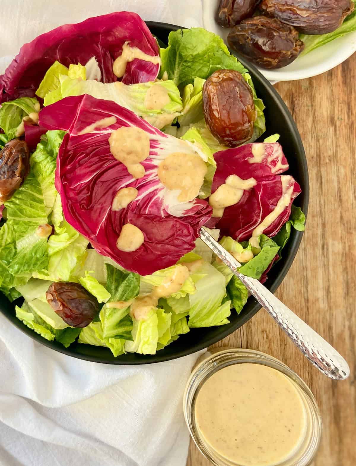 Medjool Date vinaigrette on bed of greens and radicchio.