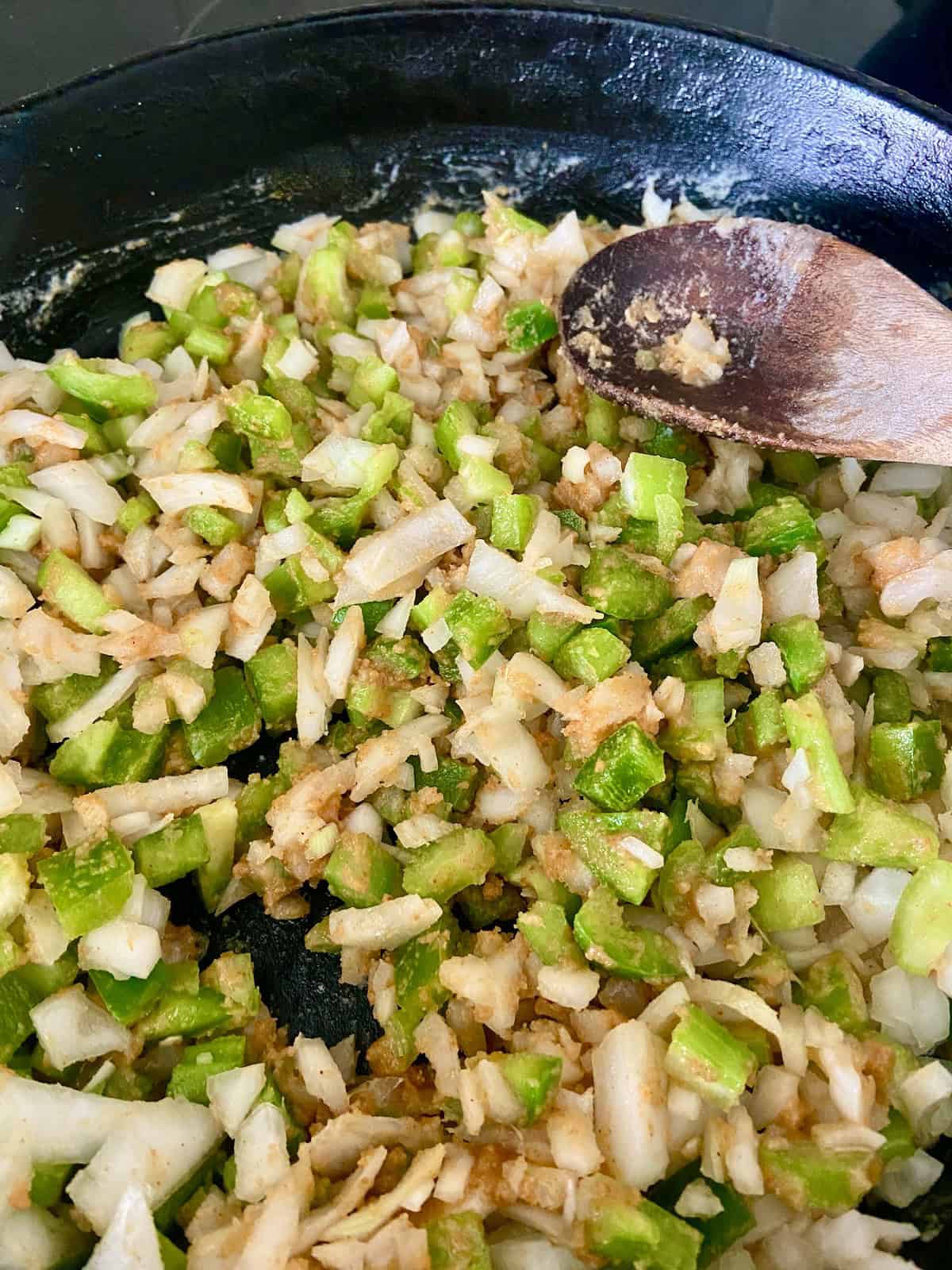 Chopped onions, green bell peppers and celery in roux.