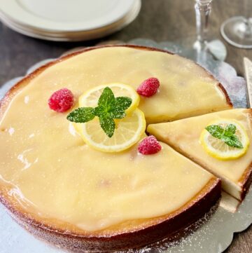 Italian Lemon Ricotta cake with Lemon Curd on serving platter.