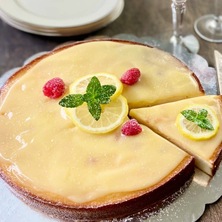 Italian Lemon Ricotta cake with Lemon Curd on serving platter.
