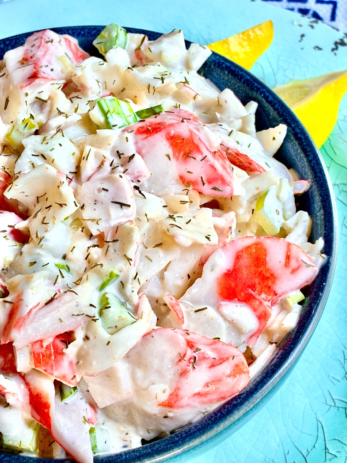 Imitation crabmeat salad in blue bowl.