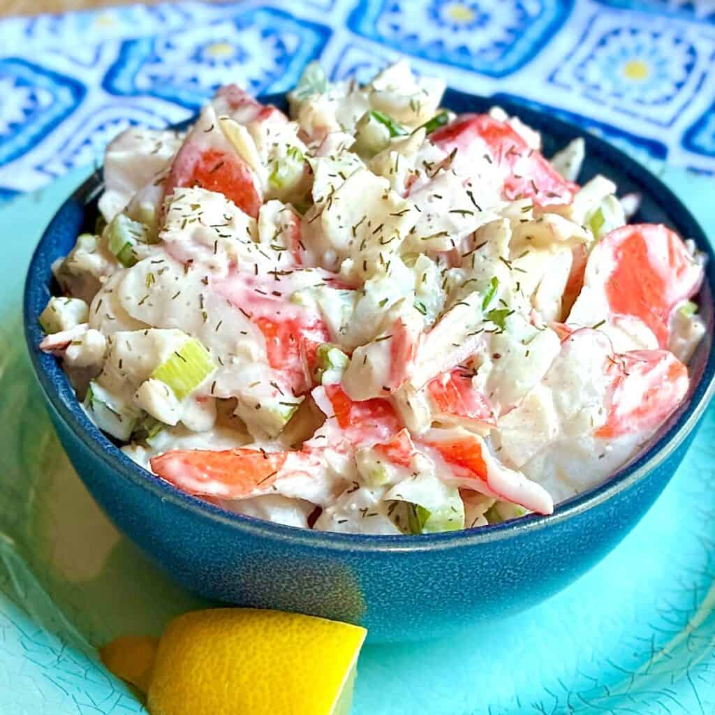 Imitation crabmeat salad in decorative blue bowl.