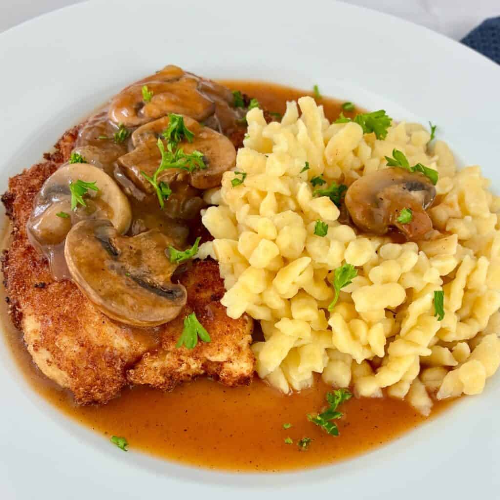 German Schnitzel in Mushroom Gravy on white plate.
