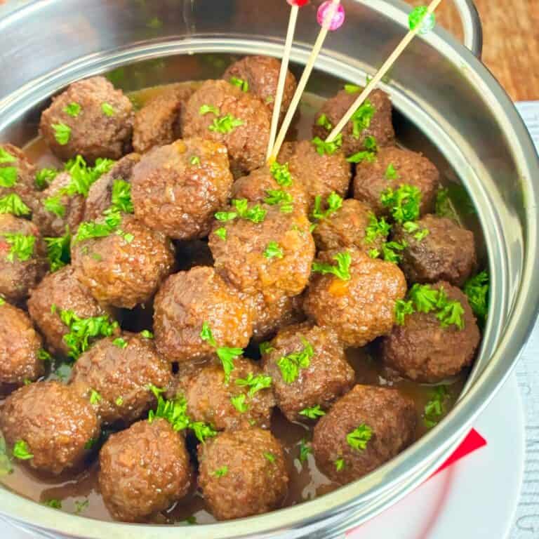 Jezebel Sauce over Meatballs in silver chafing dish.