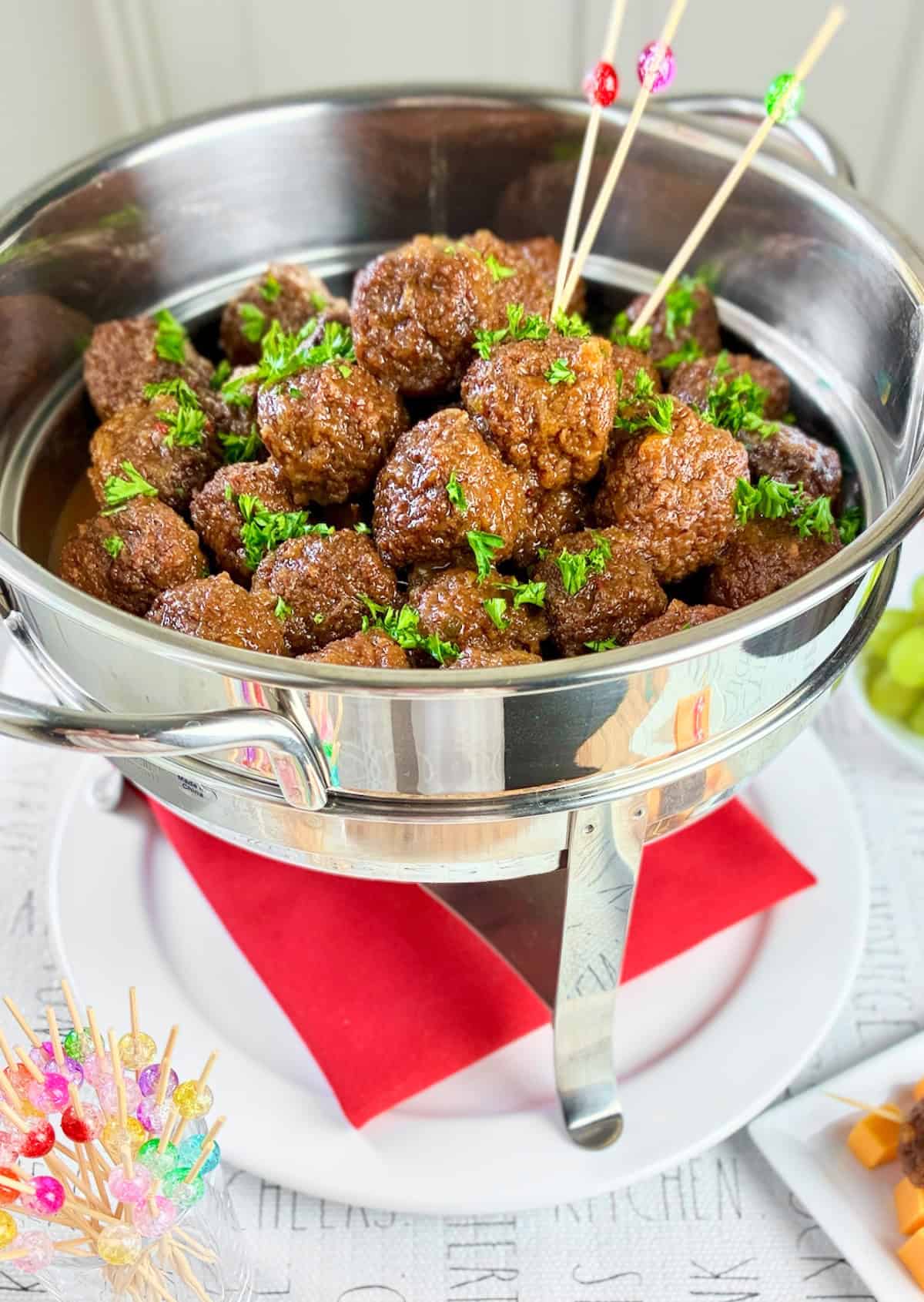 Jezebel Sauce Meatballs in silver chafing dish.