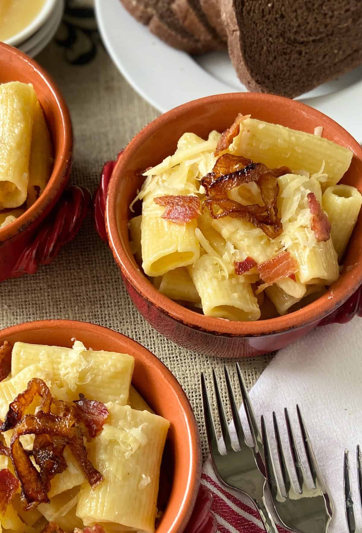 Two bowls of Alpin Macaroni in red bowls.