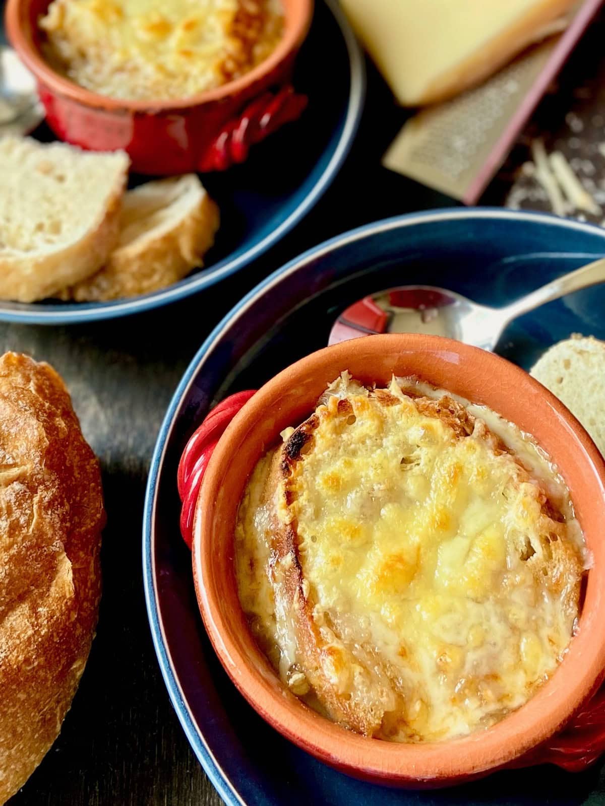 Bowl of French onion soup topped with cheese.