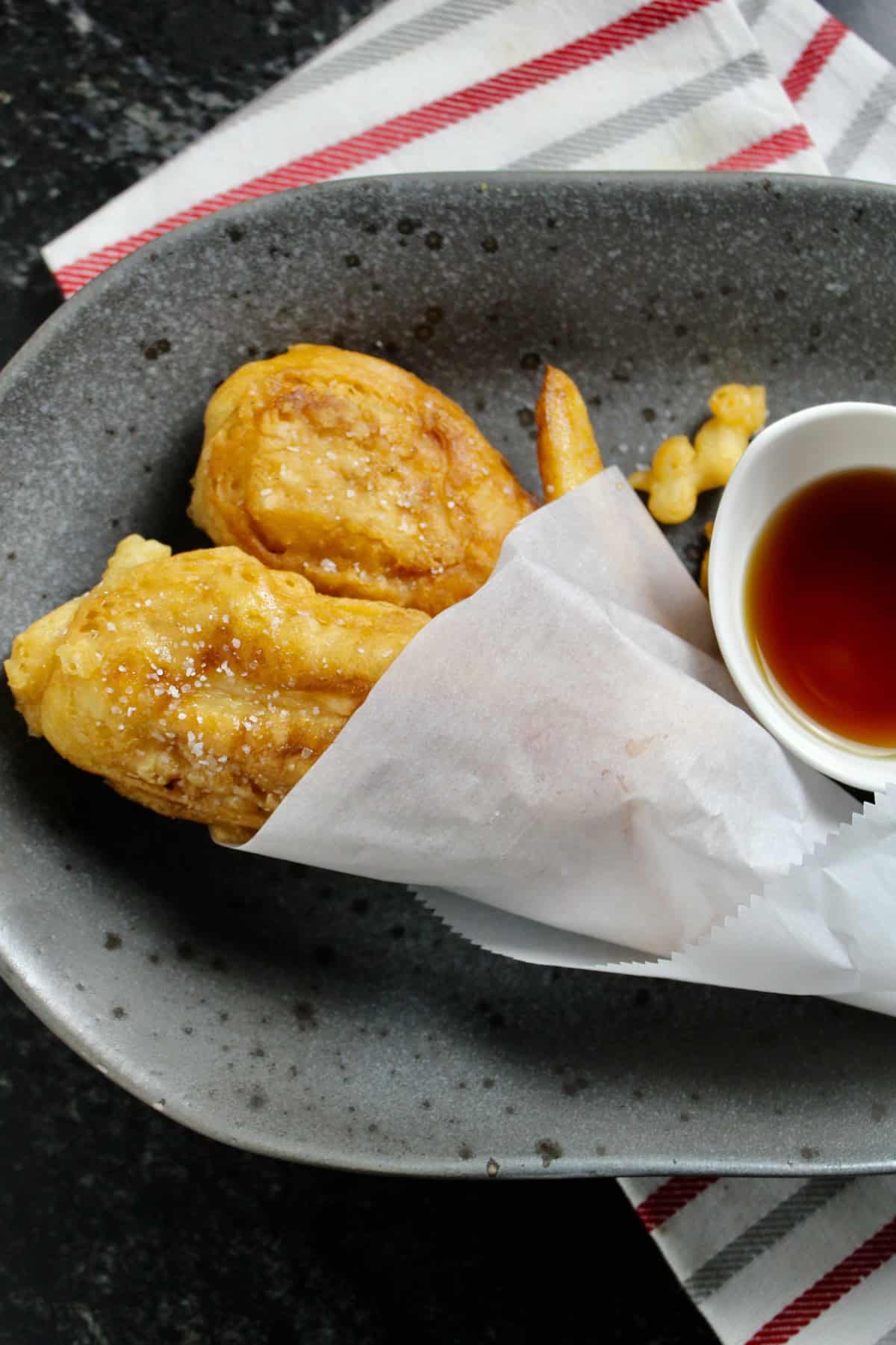 Salted fried fish wrapped in white paper.