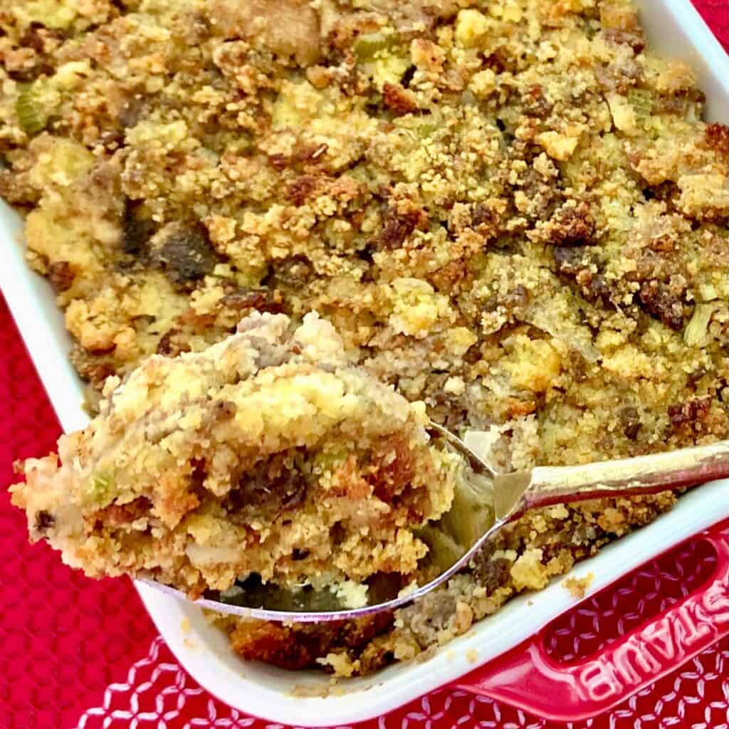 Cornbread dressing on spoon.