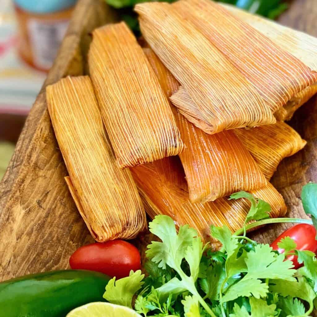 Stacked tamales in husks.
